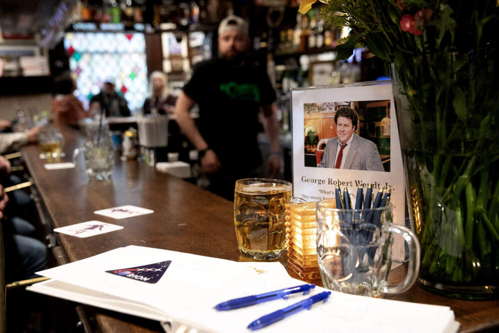 A photo of actor George Wendt stands at the end of the Cheers Bar on Beacon Street in Boston. (Robin Lubbock/WBUR)