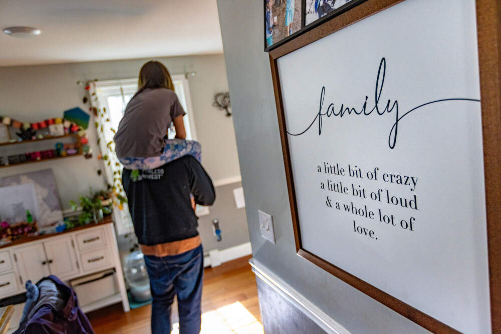 Emily rides on their father's shoulders around the family home. (Jesse Costa/WBUR)