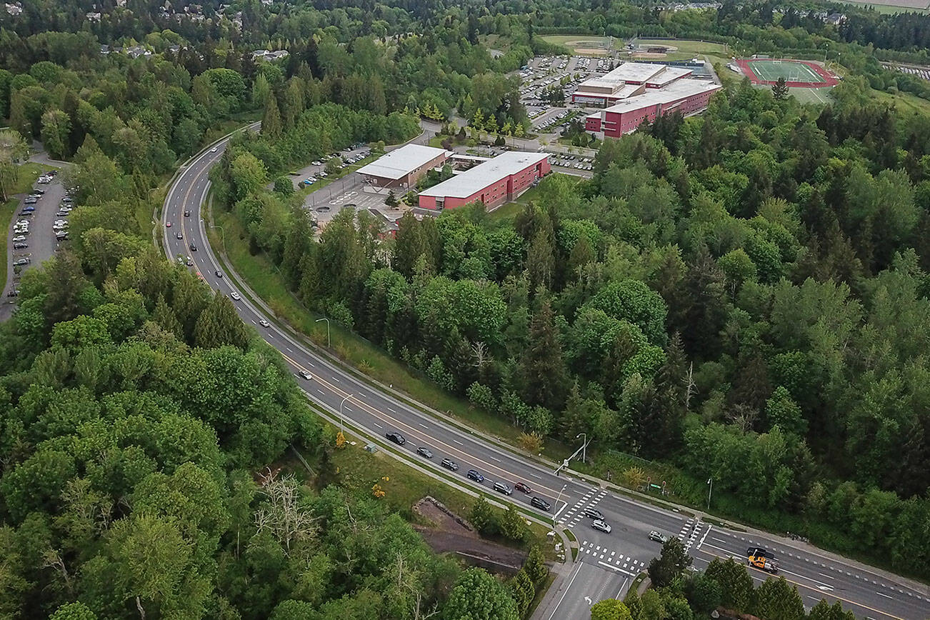 Cars drive along Cathcart Way next to the site of the proposed Eastview Village development that borders Little Cedars Elementary on Wednesday, May 7, 2025 in Everett, Washington. (Olivia Vanni / The Herald)