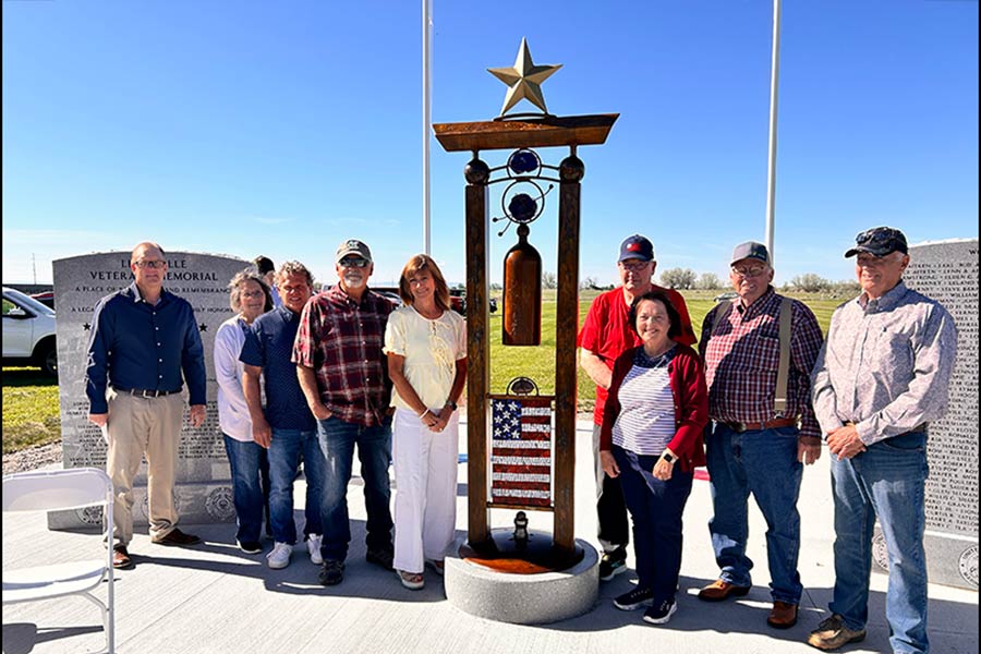 Lewisville Veterans Foundation committee poses for a photo in front of the new monument Saturday morning.