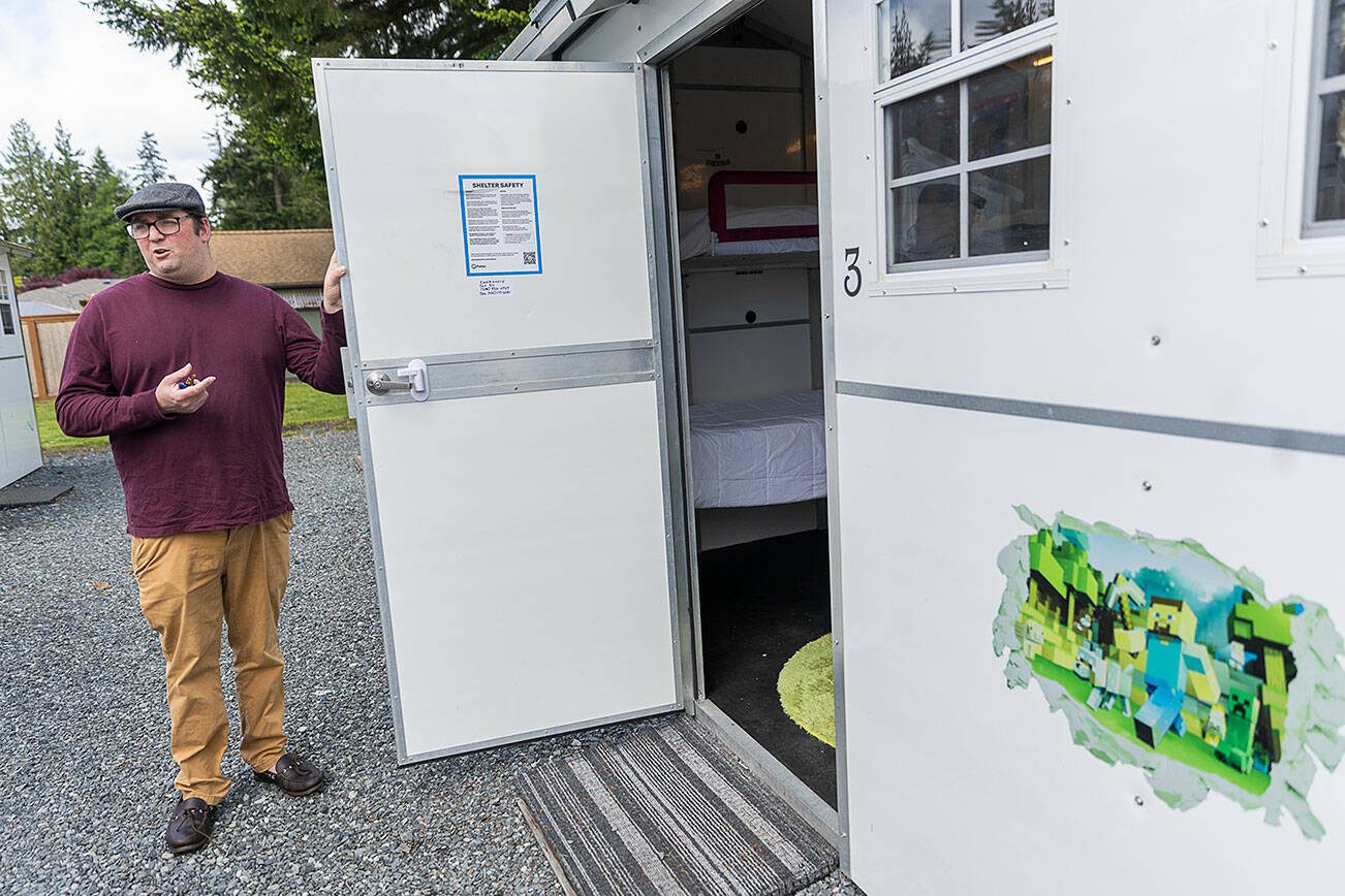 Madison Family Shelter Family Support Specialist Dan Blizard talks about one of the pallet homes on Monday, May 19, 2025 in Everett, Washington. (Olivia Vanni / The Herald)
