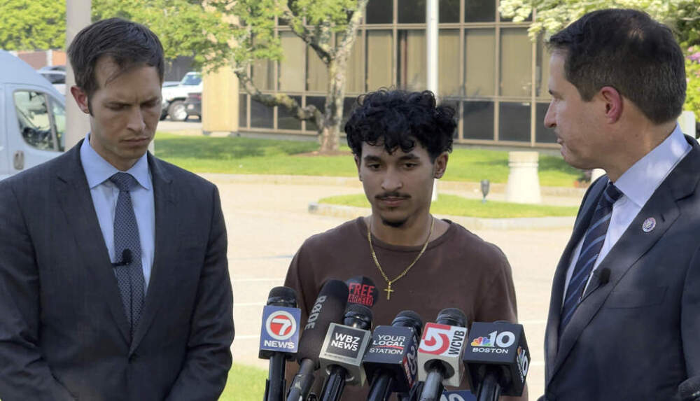 Marcelo Gomes da Silva, 18, speaks to journalists after being released from detention on bond as Reps. Seth Moulton and Jake Auchincloss listen on Thursday in Burlington. (Rodrique Ngowi/AP)
