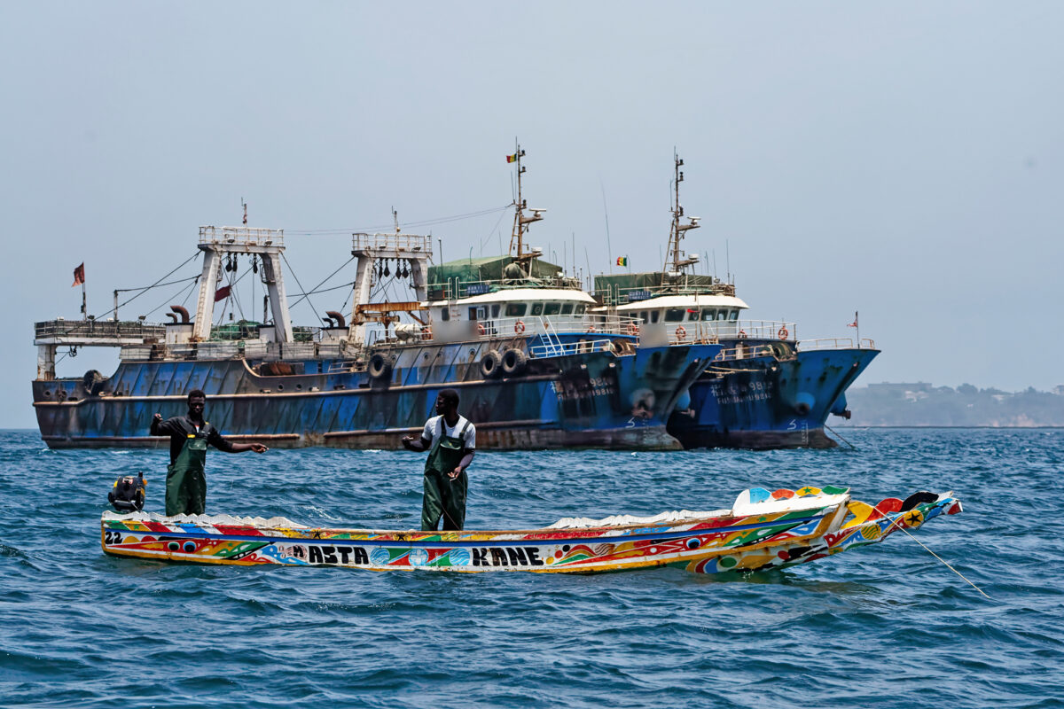 Industrial trawlers and small-scale fishers compete for space near the port of Dakar in Senegal.