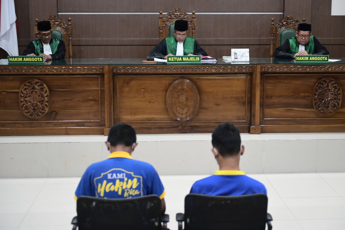 Men charged with hugging and kissing are among group publicly caned by Indonesian Islamic court