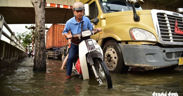 Ho Chi Minh City residents wade through flooded streets at rush hour as high tide hits again