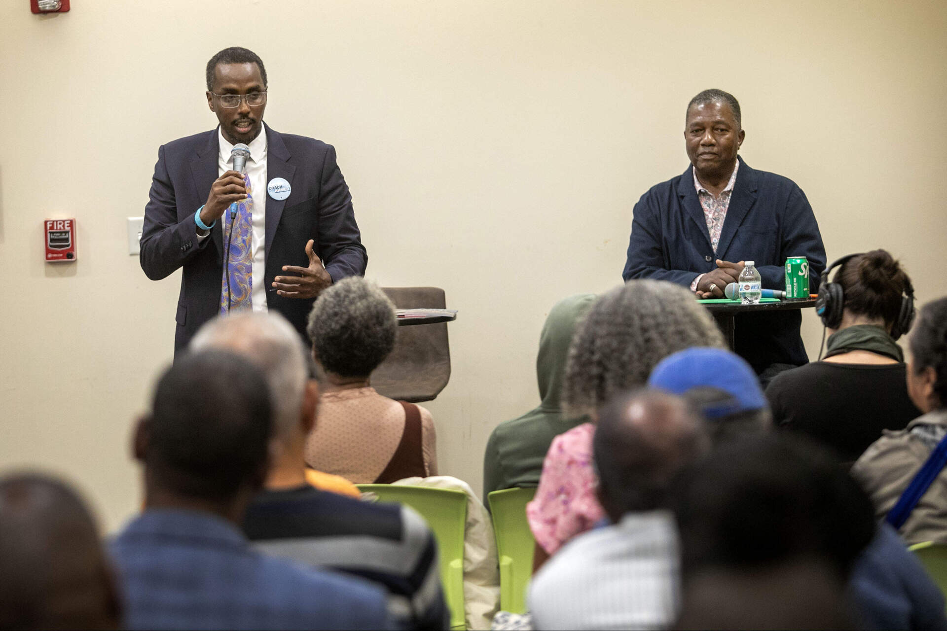 Said Ahmed, a candidate for Boston city council District 7, talks with audience members after a candidates forum at the Dudley Street Neighborhood Initiative. (Robin Lubbock/WBUR)