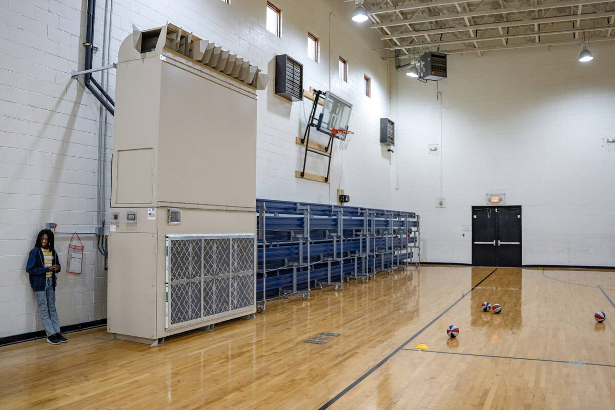 A student takes a break from basketball drills near a newly installed ultra-efficient air rotat ...