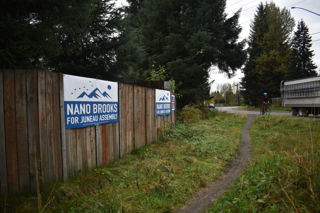 Campaign signs for Assembly candidate Nano Brooks hang on a fence in Mendenhall Valley. Brooks leads the race against incumbent Wade Bryant by just three votes in the preliminary results. (Mari Kanagy / Juneau Empire)