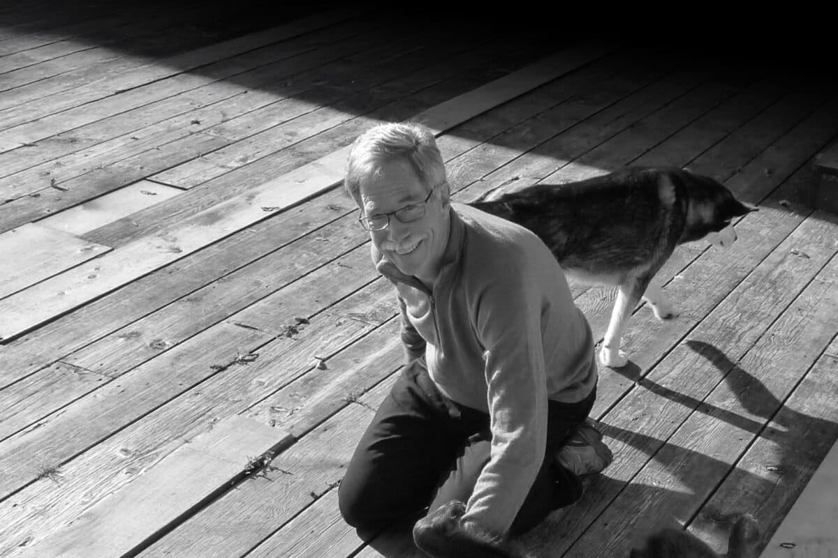 Chris Allnutt at the Heiltsuk First Nations' Koeye Lodge. The dogs are bear dogs to warn and protect the youth if there is a Grizzly bear coming into the camp. Image by Jens Wieting