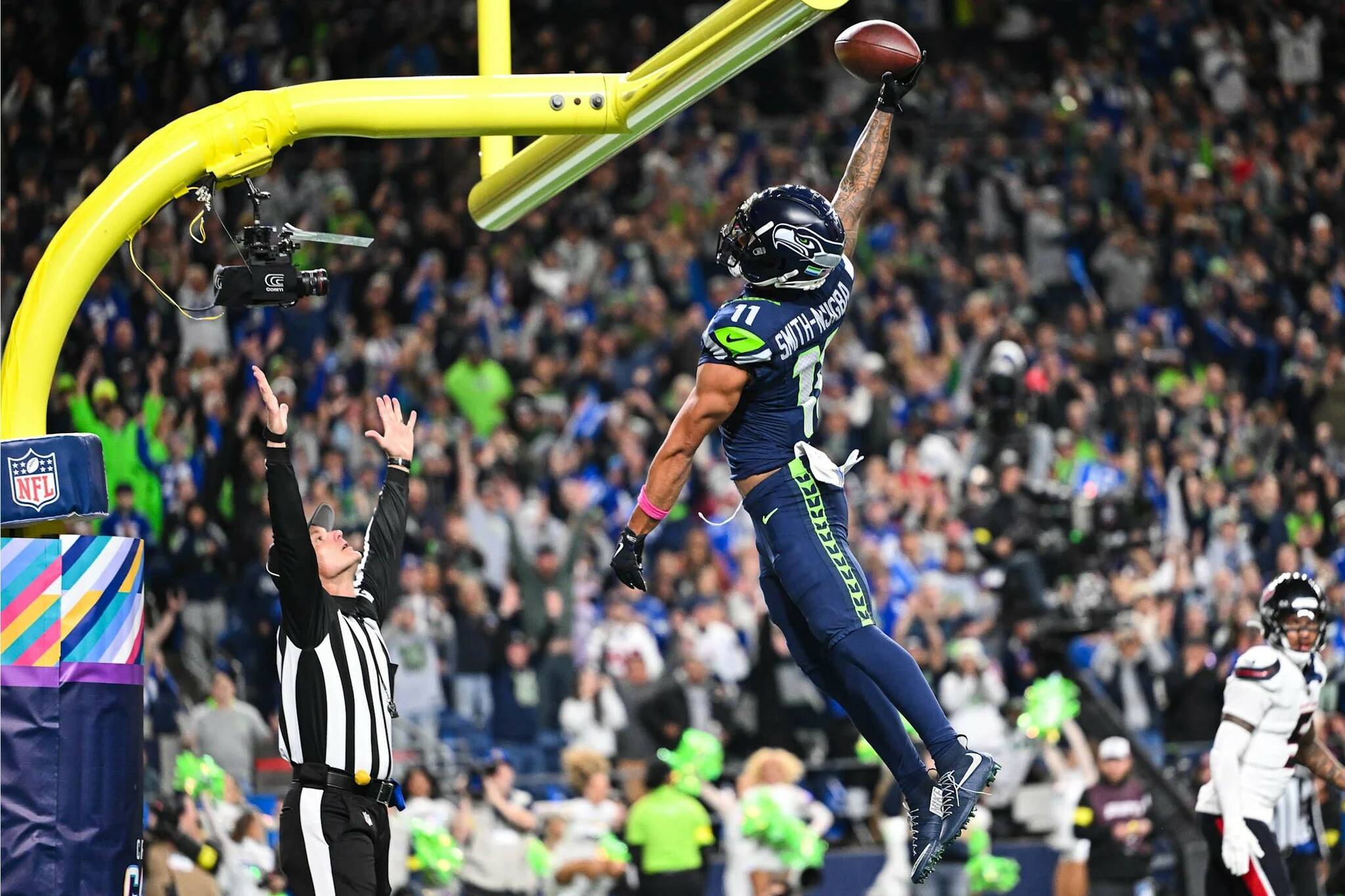 Seahawks wide receiver Jaxon Smith-Njigba dunks a football over the goalpost crossbar after scoring a touchdown against the Houston Texans Oct. 20, 2025, on Monday Night Football at Lumen Field in Seattle, Washington. (Photo courtesy of the Seattle Seahawks)
