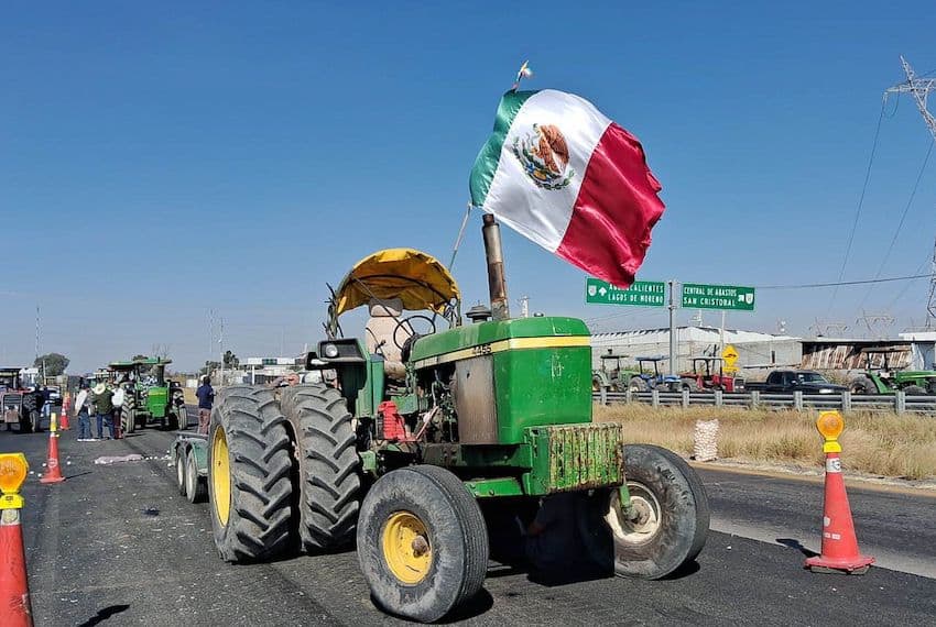 A farmer protesting corn prices in Mexico sits in his tractor during a blockade in León, Mexico