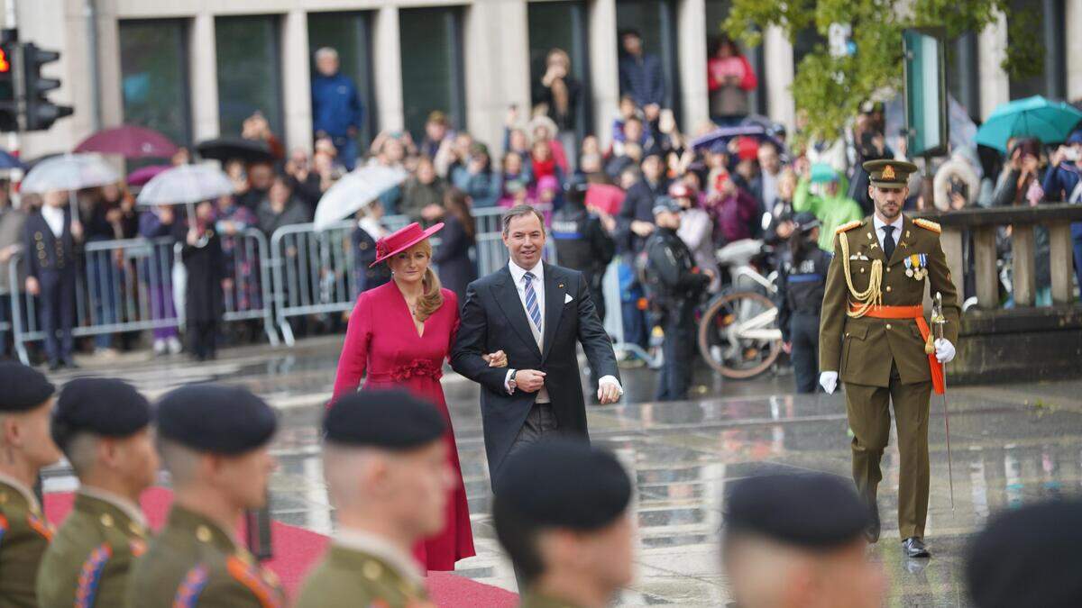 Grand Duke Guillaume and Grand Duchess Stéphanie walk towards Notre Dame cathedral in Luxembourg City during the enthronement celebrations on 5 October.