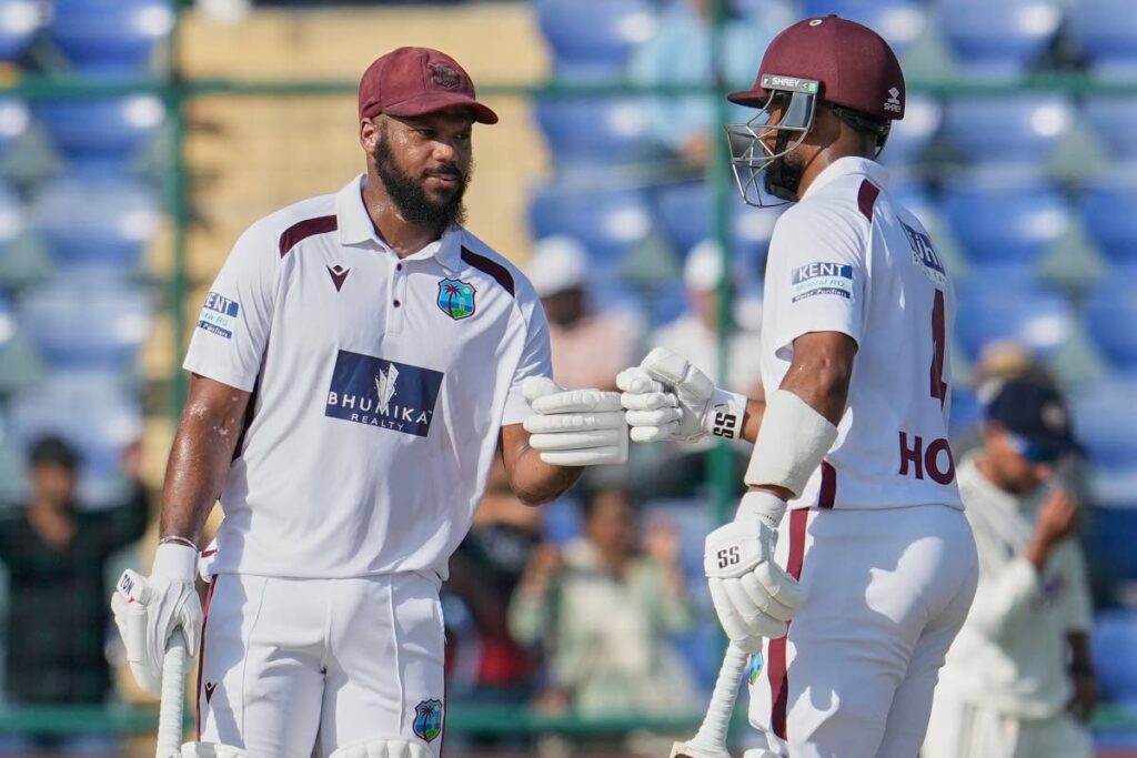 West Indies opener John Campbell, left, and Shai Hope give the fist touch on the third day of the second Test match between India and West Indies at the Arun Jaitley Stadium in New Delhi, India, on October 12. AP PHOTO - AP