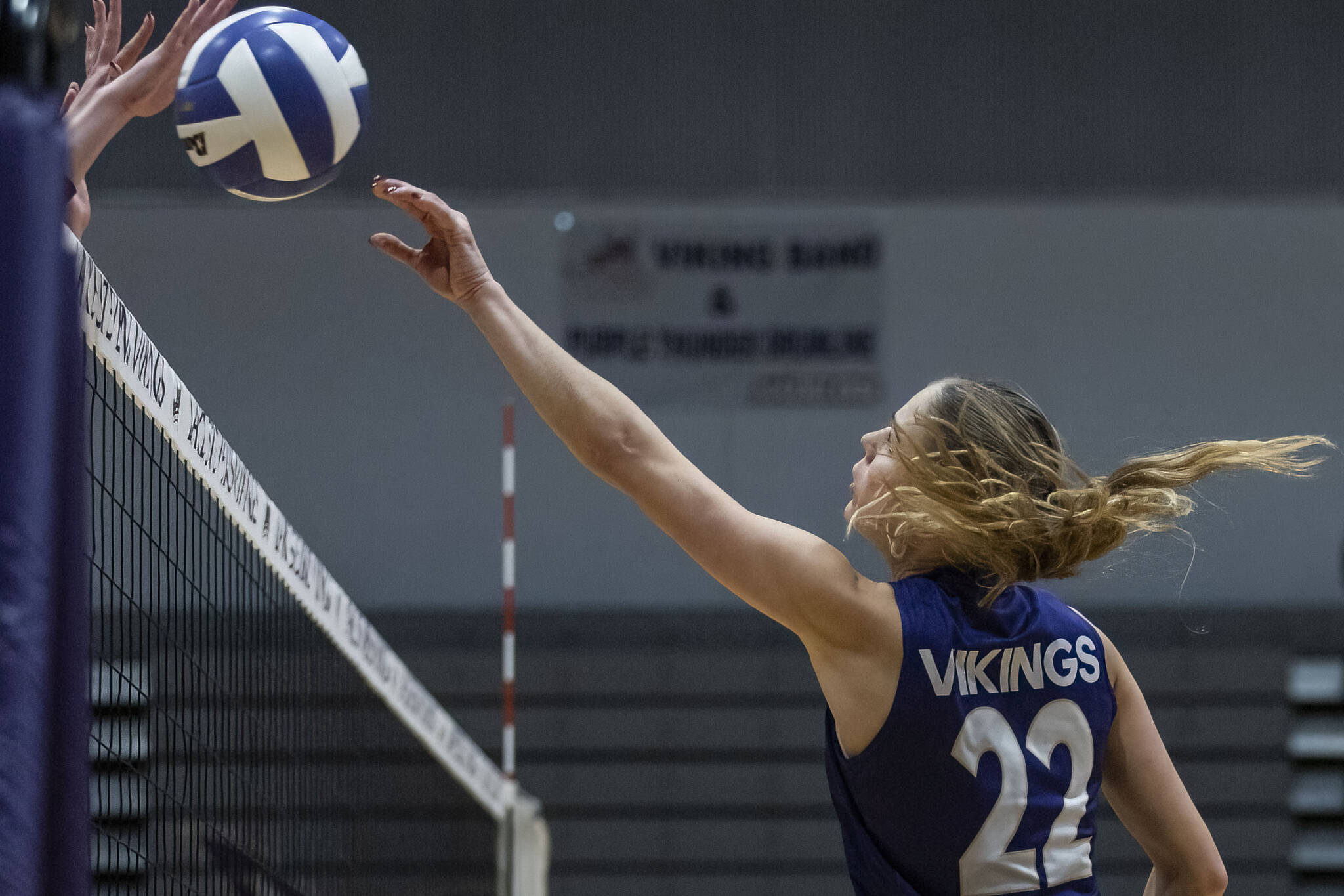 Lake Stevens’ Laura Eichert tries to tip the ball over the net during the 4A district semifinal game on Thursday, Nov. 14, 2024 in Lynnwood, Washington. (Olivia Vanni / The Herald)