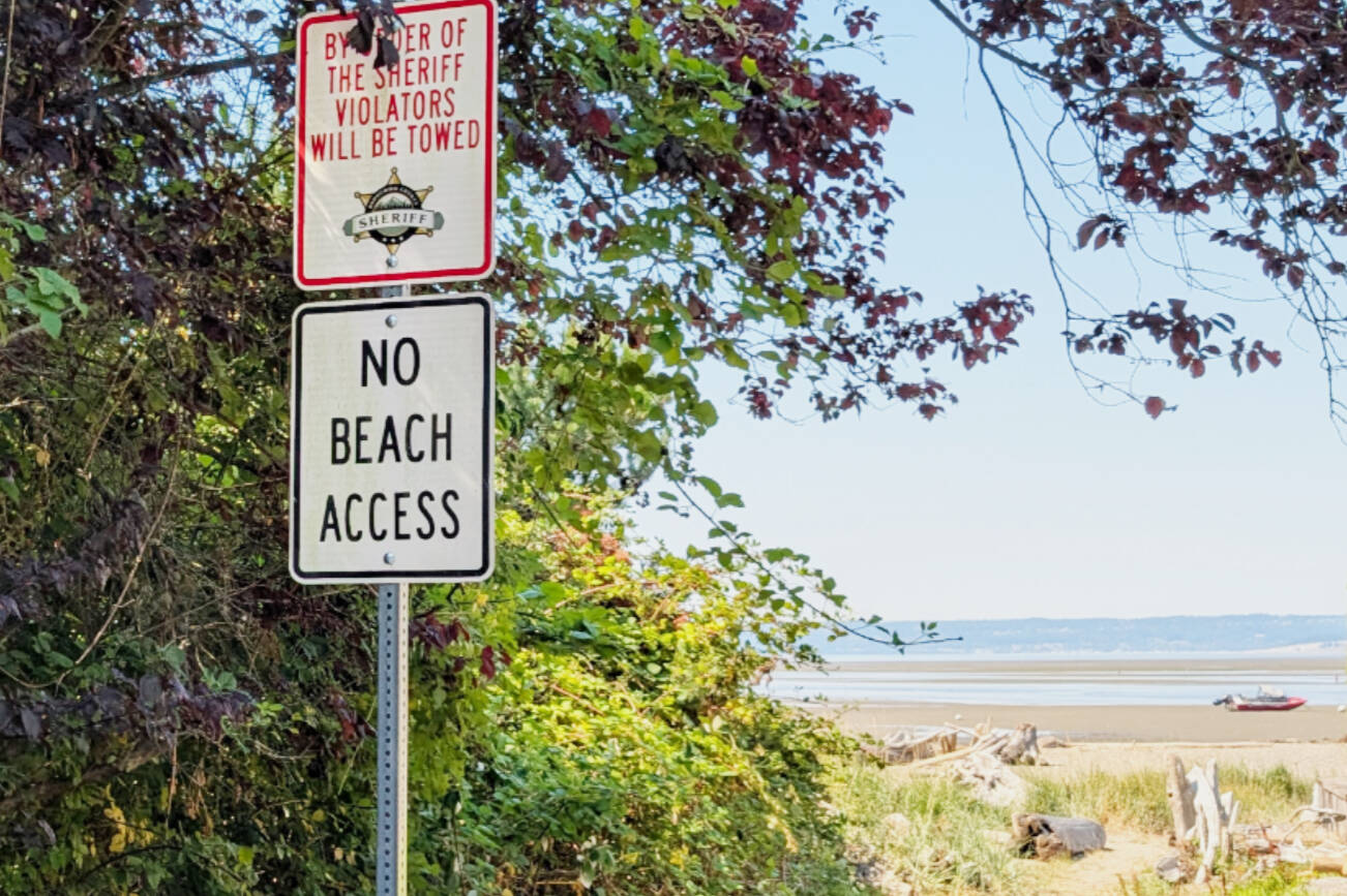 "No Beach Access" and “By Order of the Sheriff” tow-away signs installed at Hillman Place a public right-of-way near Soundview Drive Northwest in Stanwood. (K’allen Specht)