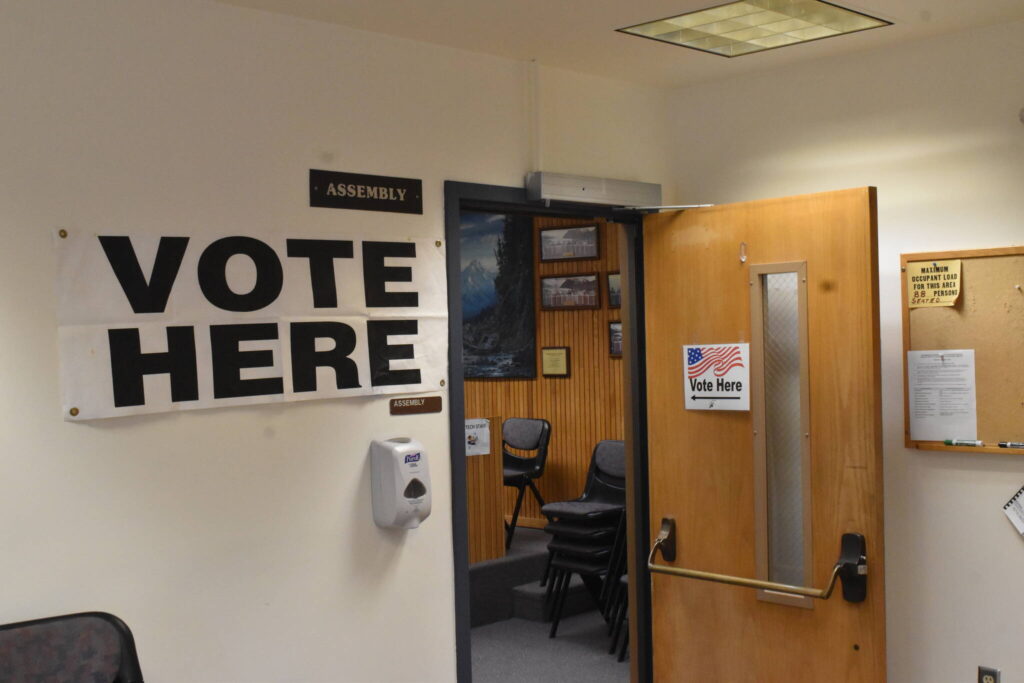 “VOTE HERE” sign directs residents to the City Hall Assembly Chamber voting center on Election Day. (Mari Kanagy / Juneau Empire)