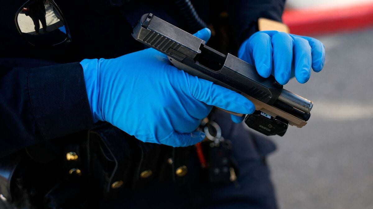 A California Highway Patrol (CHP) officer inspects a gun that was confiscated during a felony stop on 16 October. Picture for illustrative purposes.