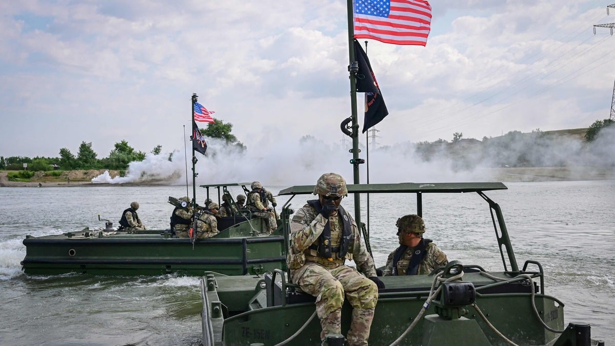 US soldiers operate vessels across the Danube River during exercises in Frecatei, eastern Romania on June 13, 2025