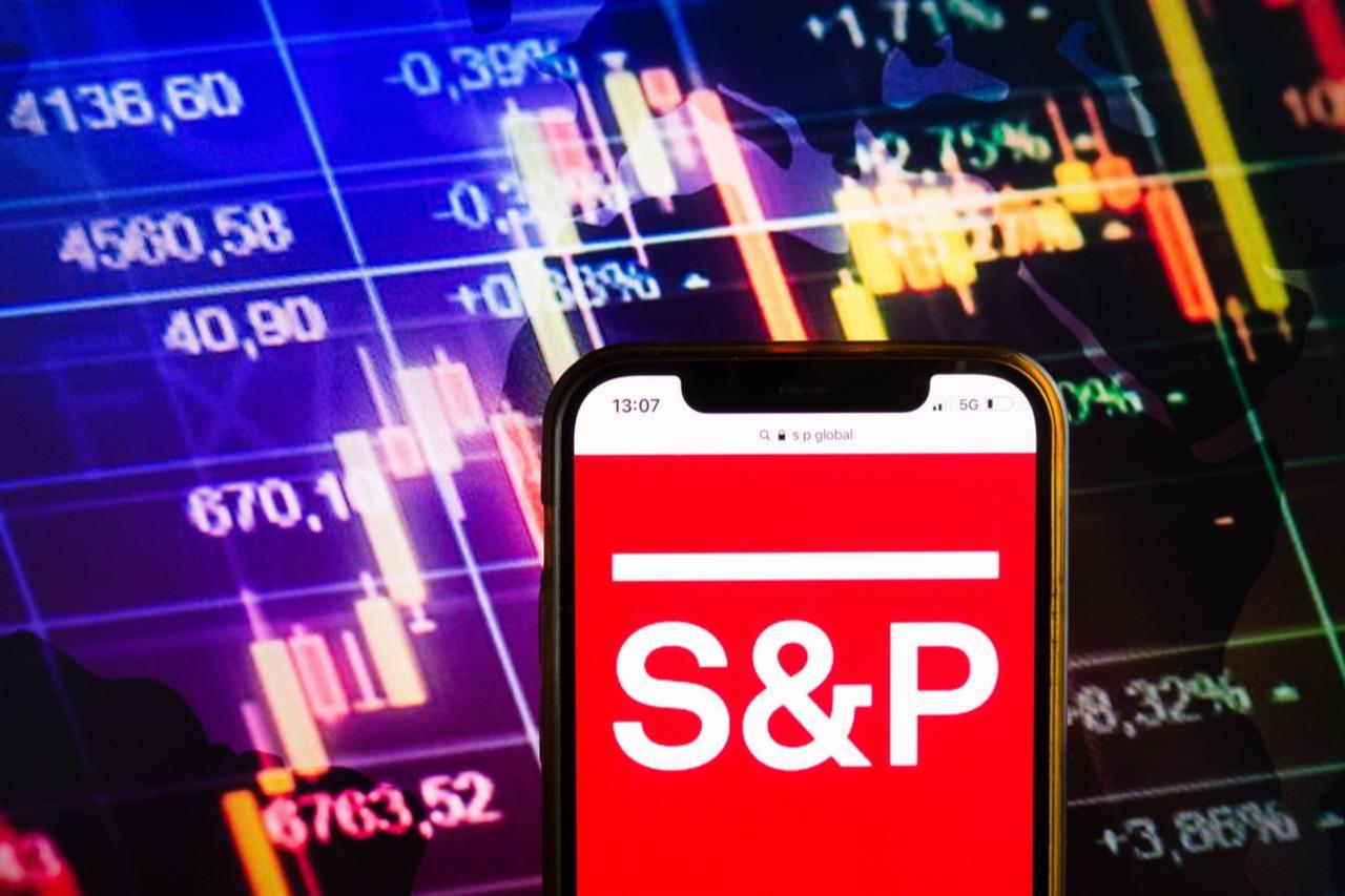 File photo shows a a smartphone displaying the S&P Global logo, set against a background of financial stock market data, accessed on Oct. 21, 2025. (Adobe Stock Photo)