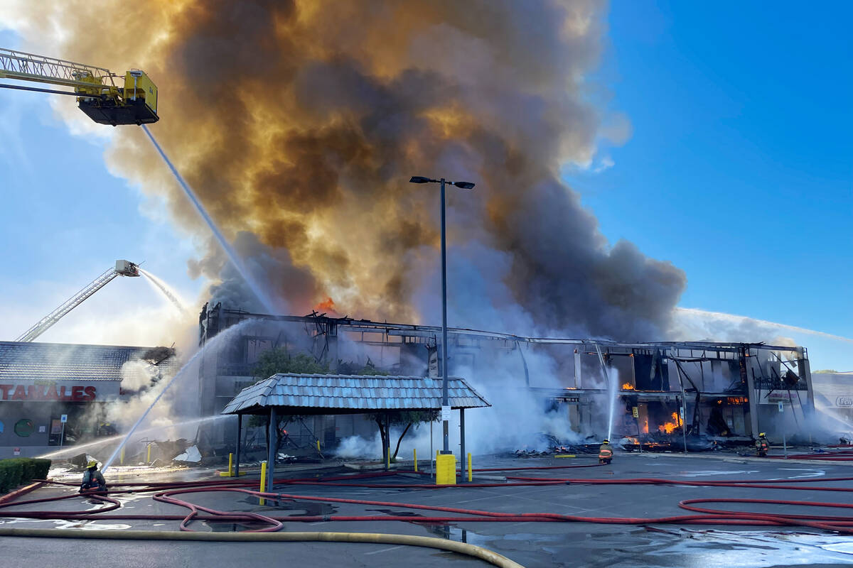 Clark County firefighters work to put out a three-alarm building fire on the 4600 block of Mary ...