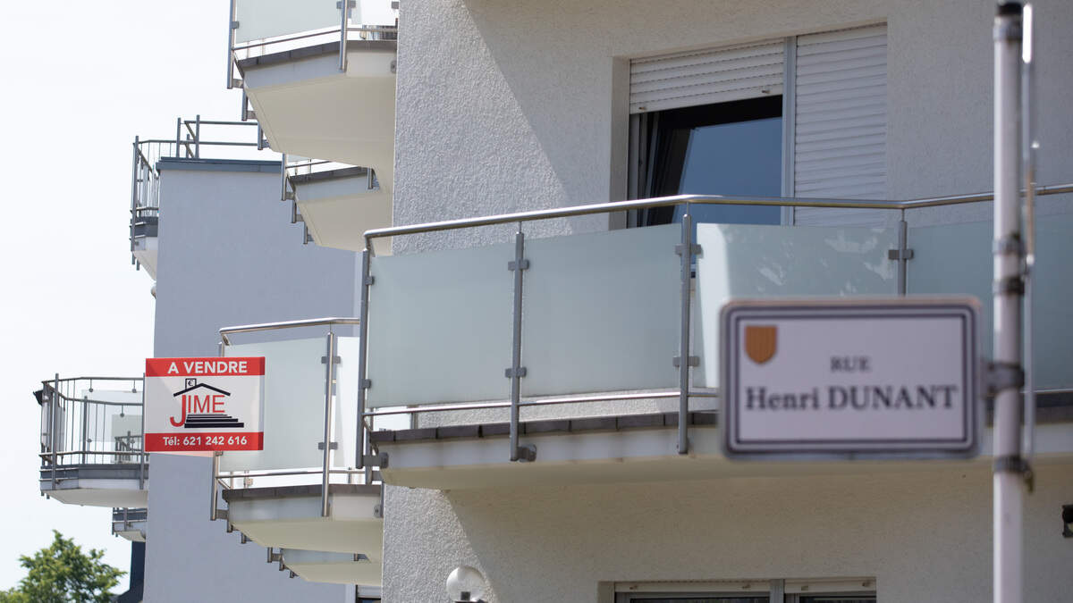 A “for sale” sign is seen on a flat balcony in Strassen in this library picture