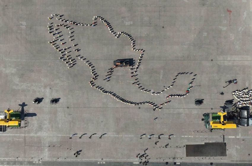 Aerial view of the line-up before the start of the parade and civic-military ceremony marking the 115th anniversary of the start of the Mexican Revolution in the Zócalo square.
