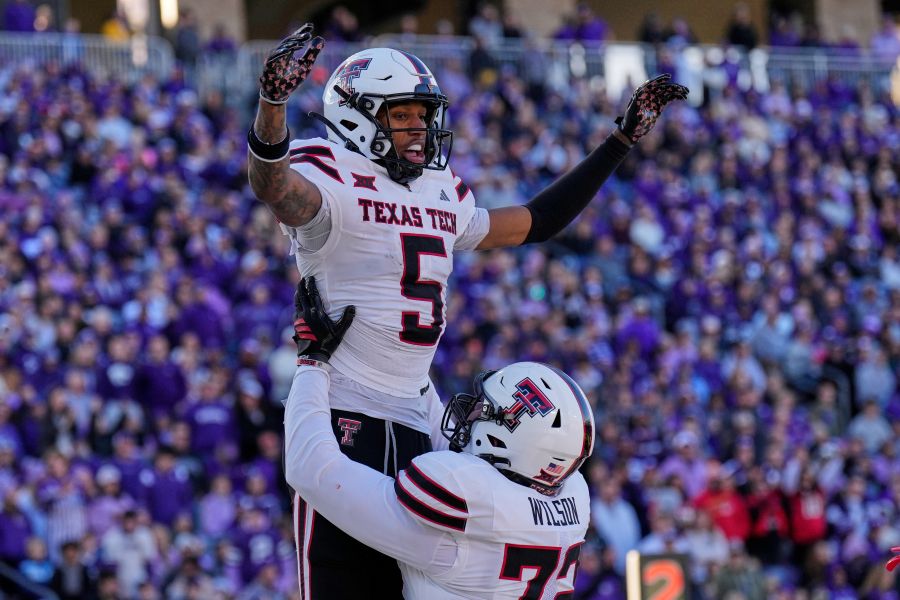 Texas Tech wide receiver Caleb Douglas (5) celebrates with offensive lineman Sheridan Wilson after scoring a touchdown during the second half of an NCAA college football game against Kansas State, Saturday, Nov. 1, 2025, in Manhattan, Kan. (AP Photo/Charlie Riedel)