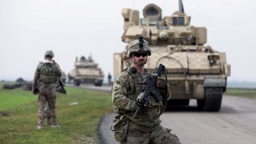 A soldier from the US-led Coalition stands during a joint US–SDF patrol in rural Qamishli (al-Hasakah province, northeastern Syria), February 8, 2024 (Reuters/Orhan Qariman)