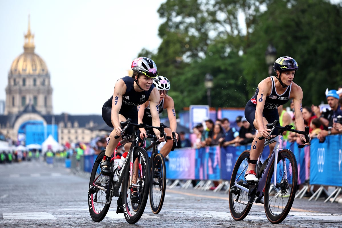 Britain’s Kate Waugh overcomes exhaustion to clinch dramatic first triathlon world title