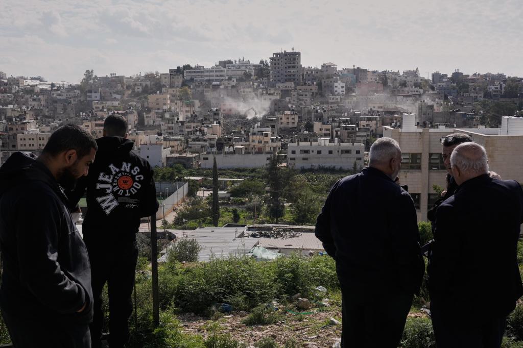 Palestinians watch Israeli bulldozers claw down their West Bank homes