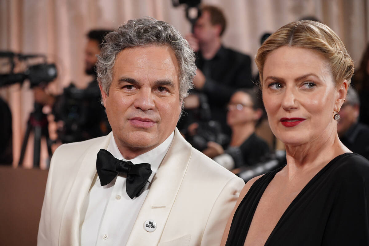 Mark Ruffalo, left, and Sunrise Coigney arrive at the 83rd Golden Globes on Sunday, Jan. 11, 20 ...