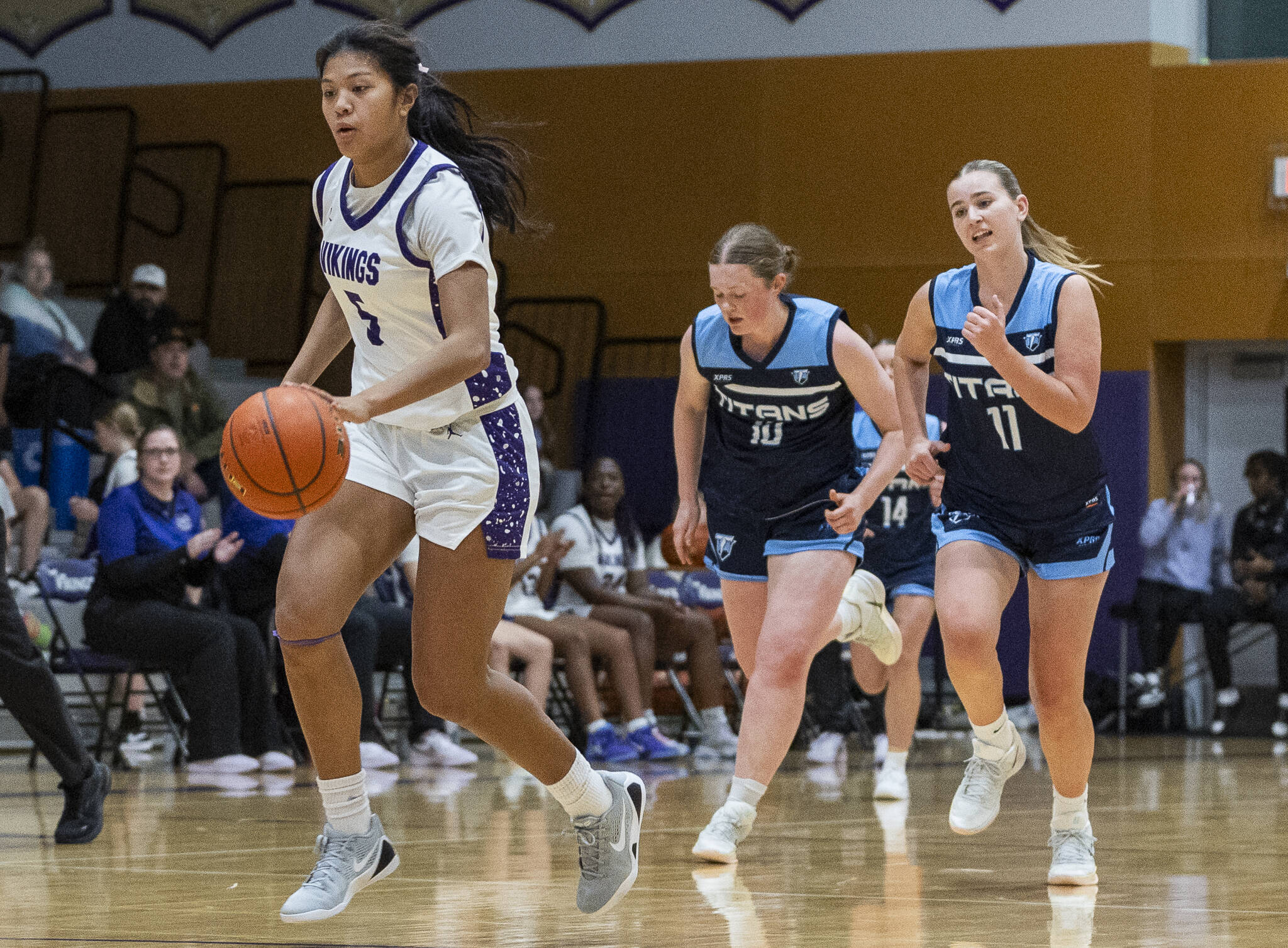 Lake Stevens’ Noelani Tupua steals the ball and dribbles up the court for a layup against Tenison Woods on Dec. 2, 2025 in Lake Stevens, Washington. (Olivia Vanni / The Herald)