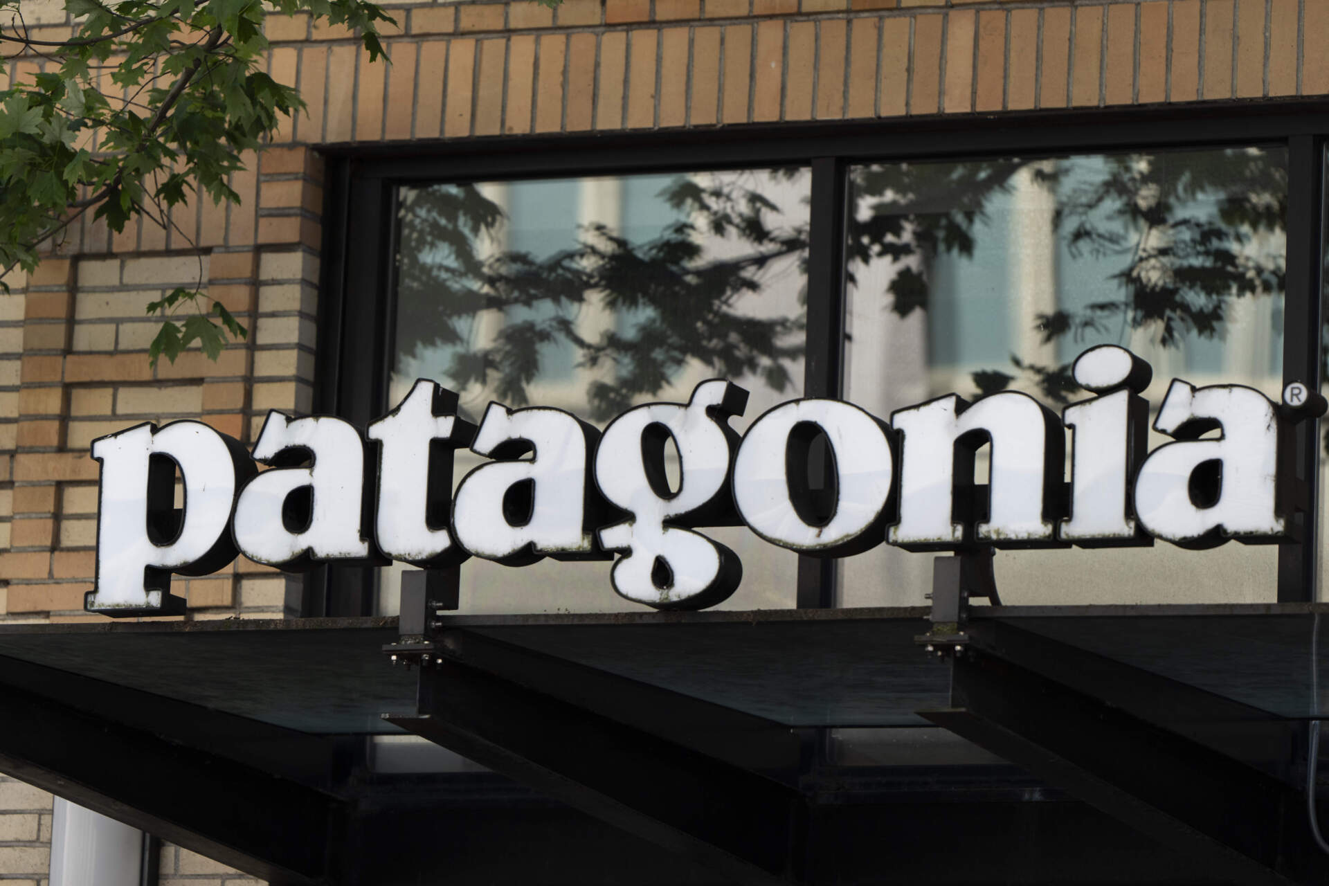 A sign for Patagonia is seen outside a store location on Tuesday, May 14, 2024, in Portland, Ore. (Jenny Kane/AP)