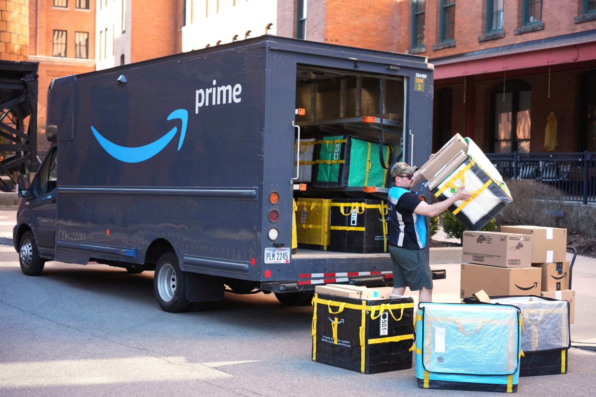 An Amazon Prime driver makes a delivery outside an apartment building in Pittsburgh, March 10, 2025. (AP Photo/Gene J. Puskar, File)