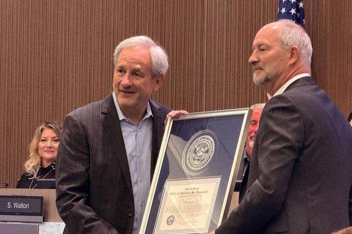 Brian Yost, left, receives a designation from Gov. Joe Lombardo, presented by Las Vegas Convent ...