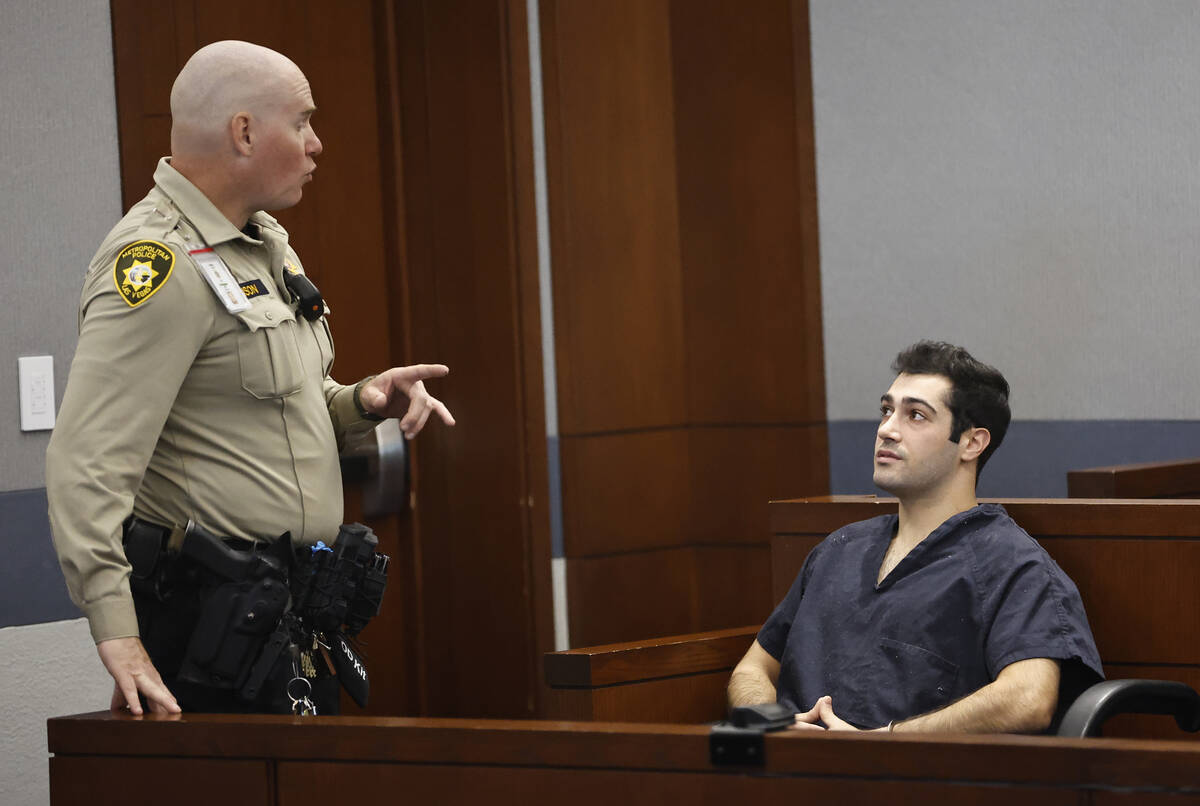 Gavin Caci, right, gets instruction from a bailiff before the start of his bail hearing at the ...
