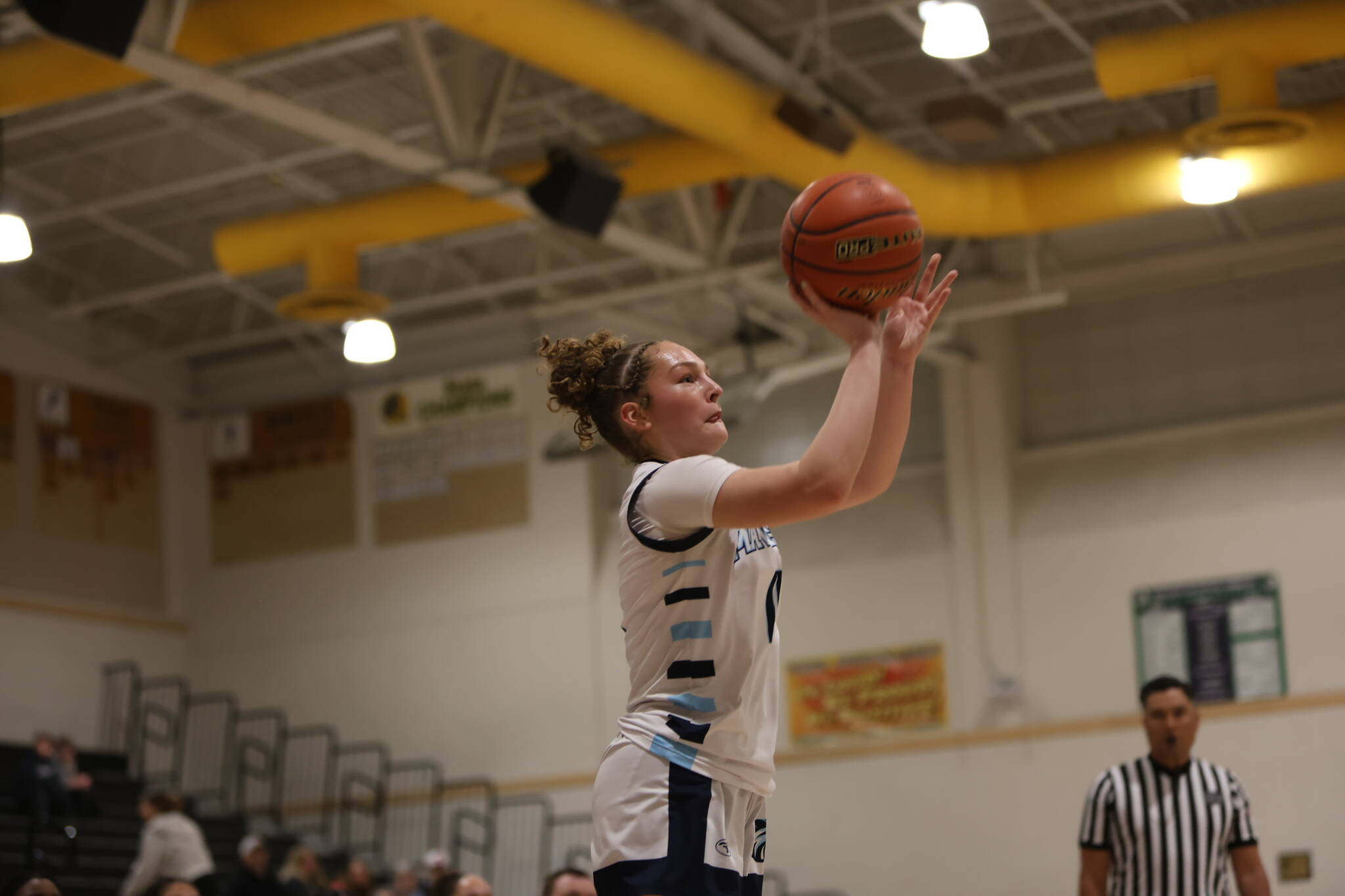 Meadowdale's Mia Brockmeyer takes a 3-pointer during a state basketball game against River Ridge on Tuesday, Feb. 24, 2026 at Edmonds-Woodway H.S. in Edmonds. (Qasim Ali / The Herald)