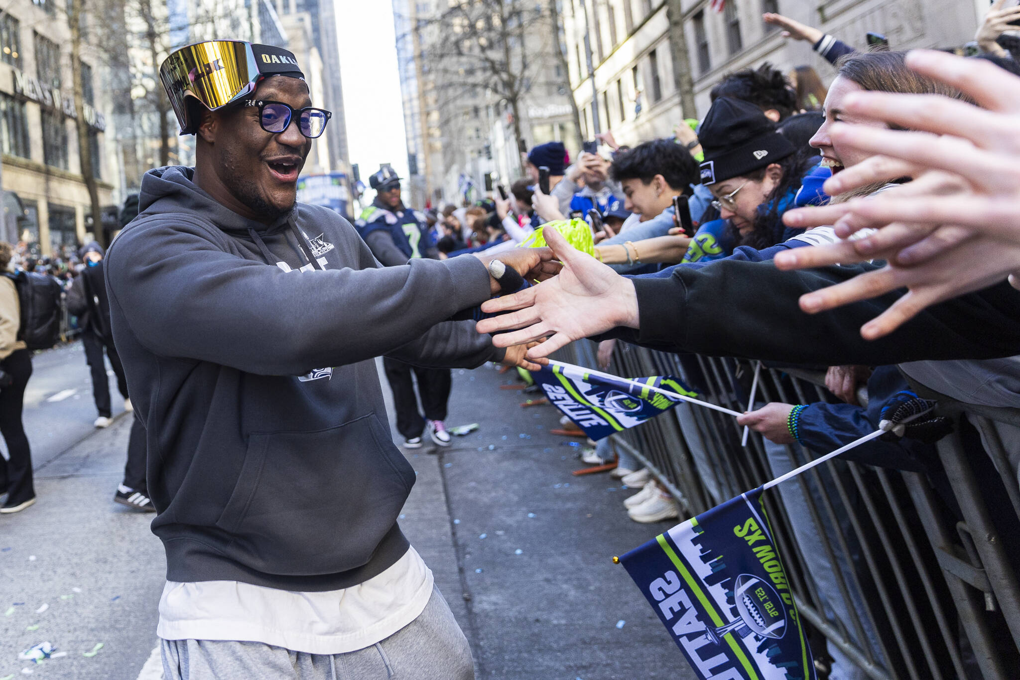 Seattle Seahawks’ Kenneth Walker III and Super Bowl MVP high fives fans lined up along 4th Avenue during the Seahawks World Champions Parade on Wednesday, Feb. 11, 2026 in Seattle, Washington. (Olivia Vanni / The Herald)