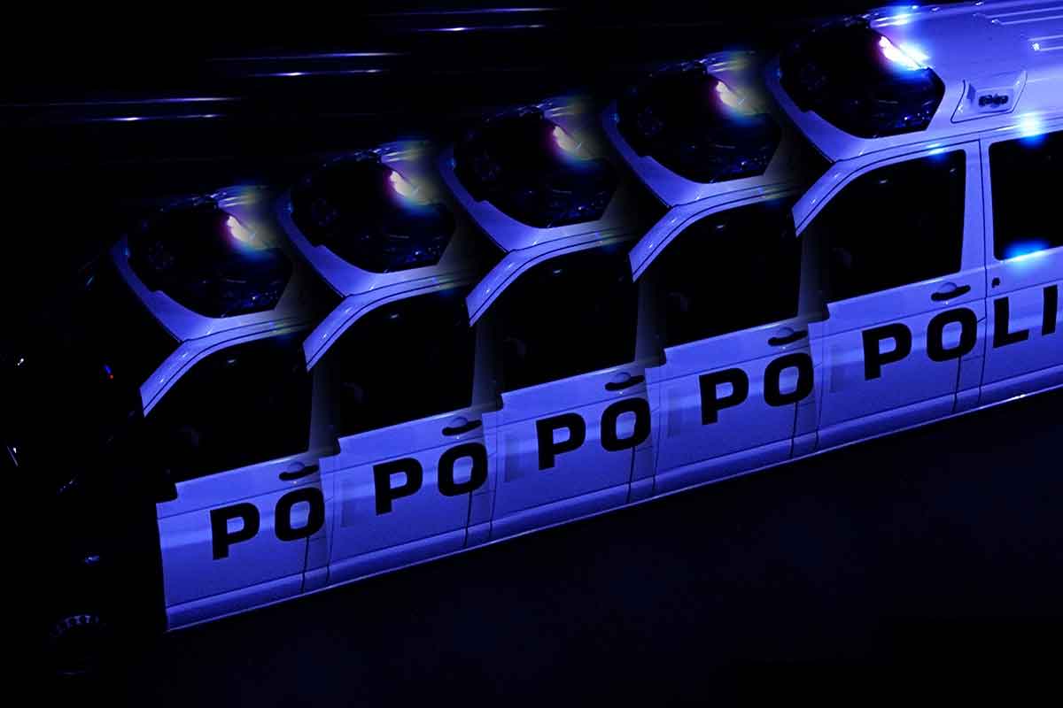 An illustrative photograph in blue hues shows a row of police cars, captured by Finland Today.