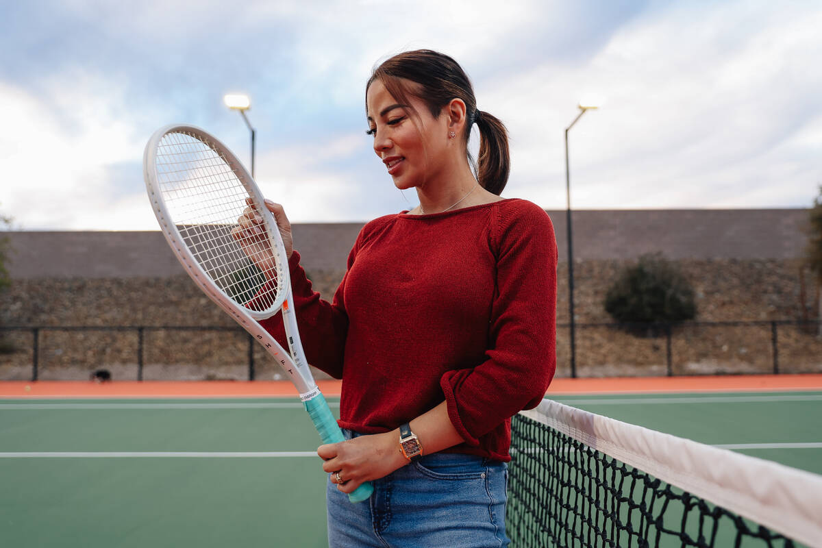 Poi Kulzer, a member of Tennis With Friends, poses for a portrait on her tennis court at her ho ...