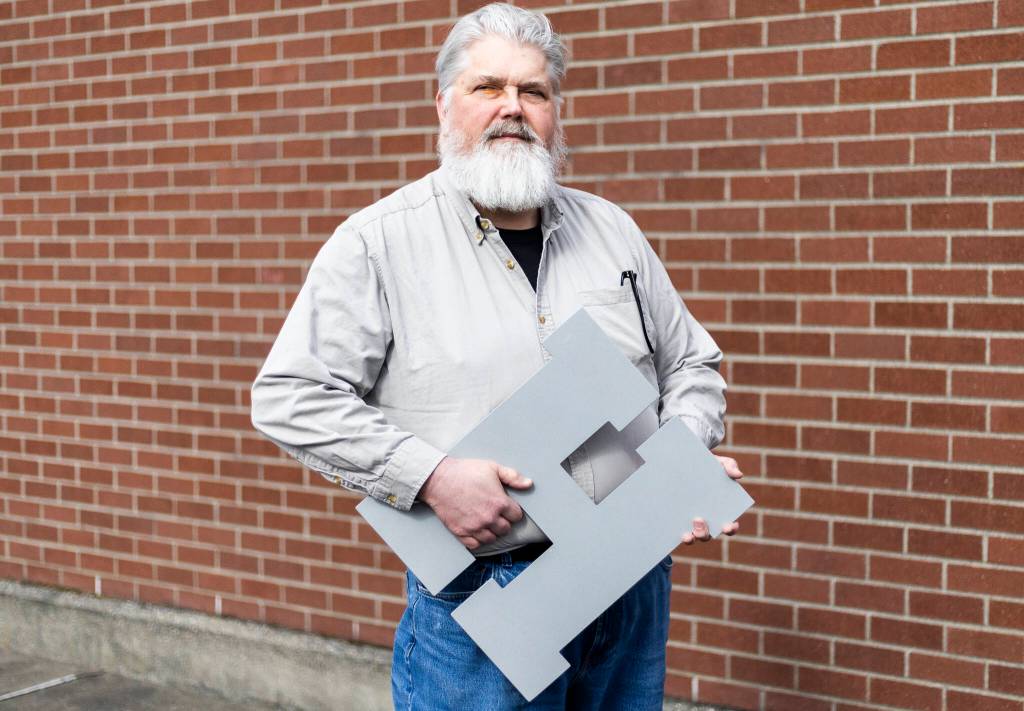 Jon Bauer, the Everett Herald’s opinion editor and Herald employee for over 24 years, outside the newspapers new office building along Hewitt Avenue on Tuesday, March 10, 2026 in Everett, Washington. (Olivia Vanni / The Herald)