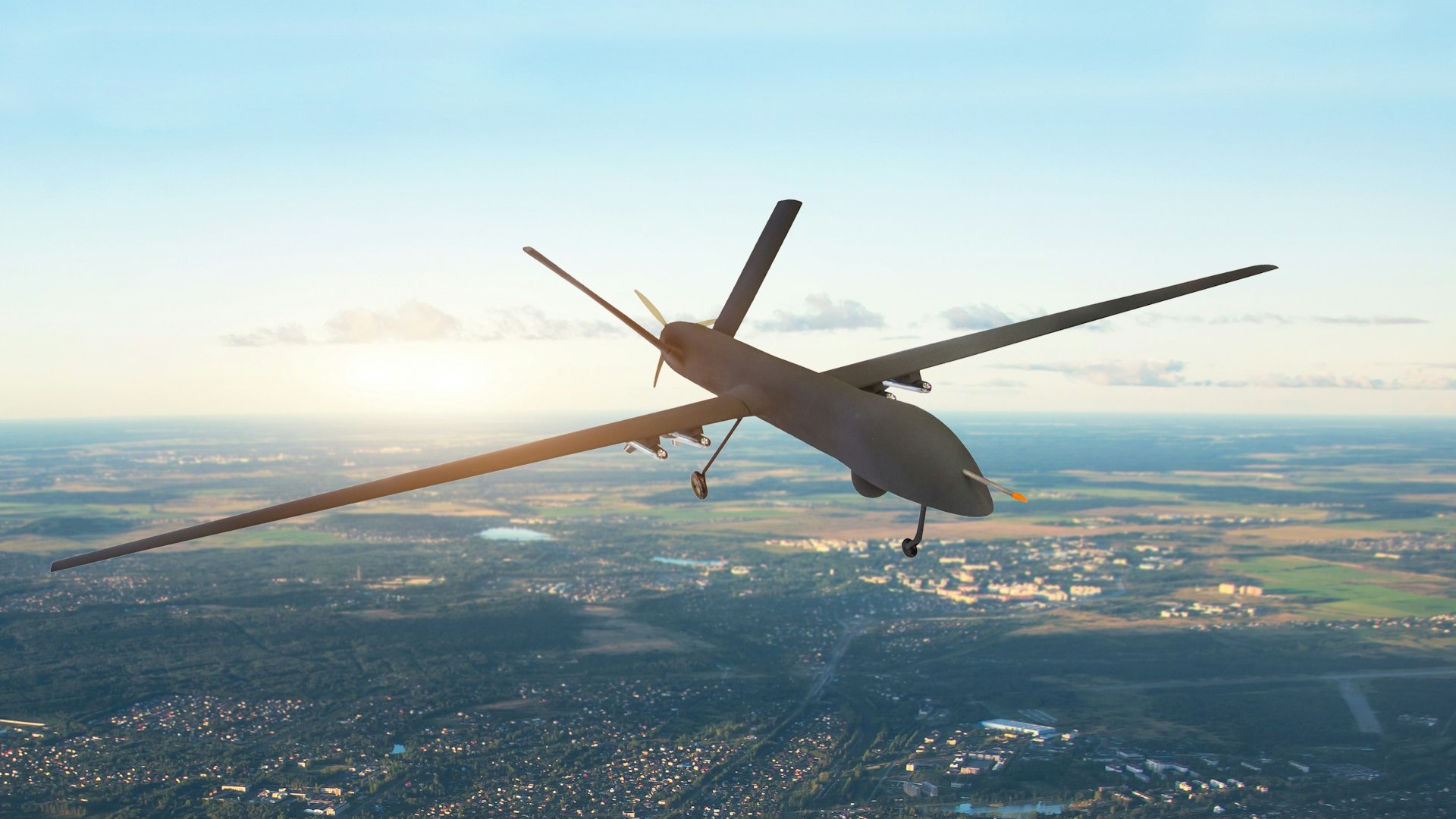 A military drone flies over a landscape at dawn, illustrating the air threat that prompted overnight alerts across Estonia. Image: Getty / Unsplash