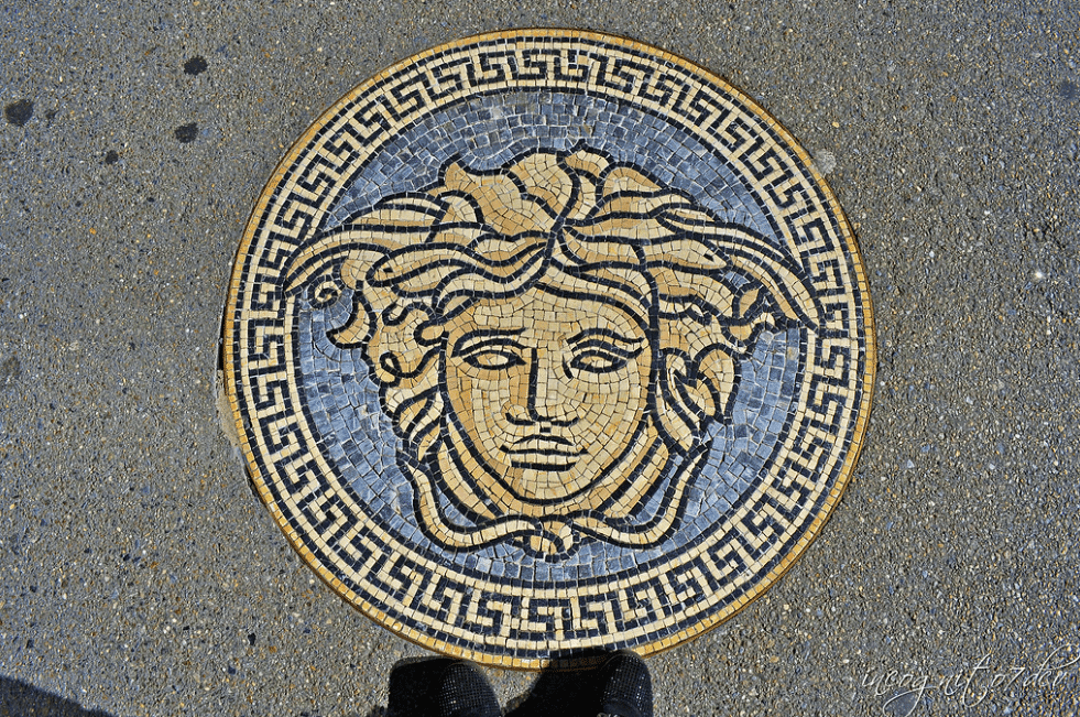 A mosaic of Medusa embedded in a pavement, symbol of Versace , inspired by Greek mythology