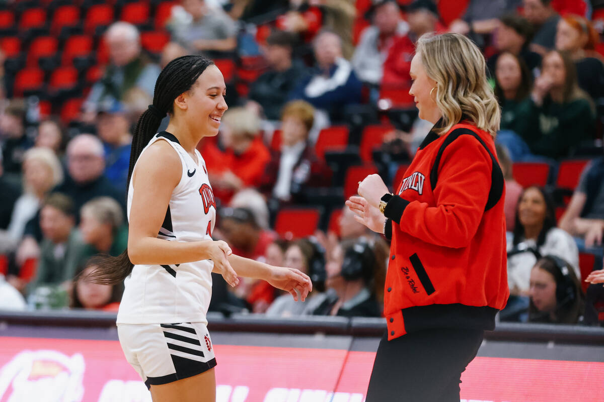 UNLV guard Mariah Elohim (2) claps hands with UNLV head coach Lindy la Rocque during a timeout ...