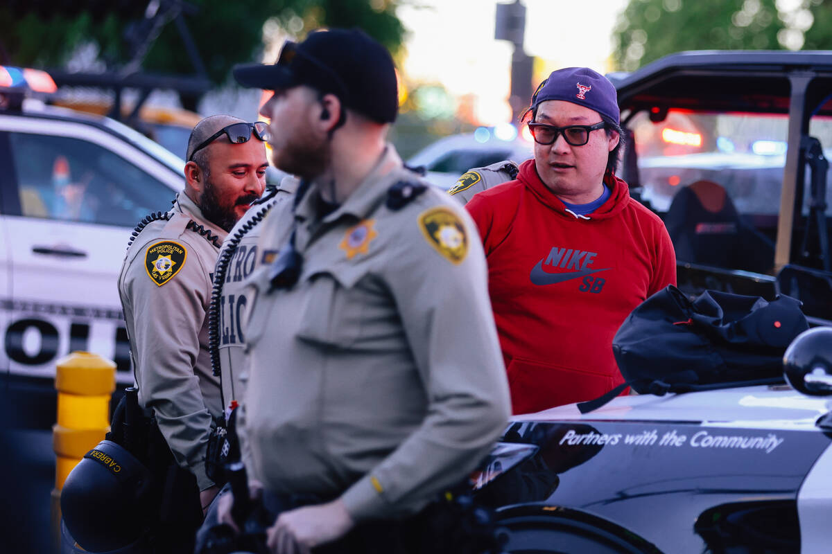 A person is arrested during a “No Kings” protest outside of the Lloyd D. George F ...