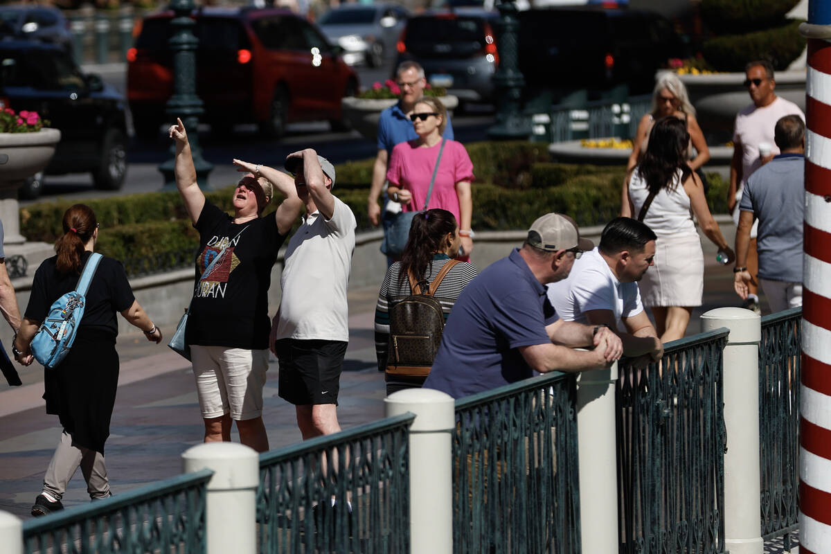 People walk along Las Vegas Boulevard during unseasonably warm weather Thursday, Feb. 26, 2026. ...