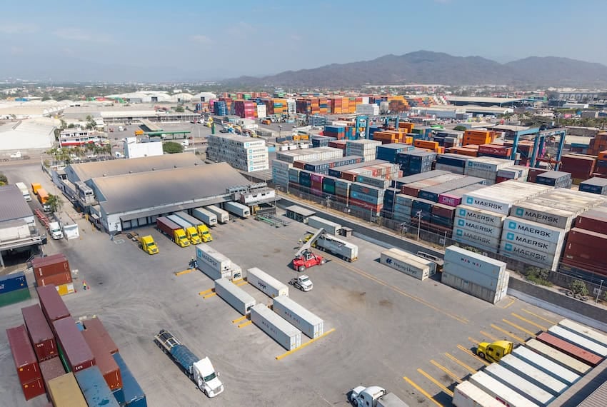 Container yard at the port of Manzanillo, showing stacked shipping containers, cargo trucks, and heavy equipment in operation. Manzanillo, Colima, Mexico, May 2, 2025.