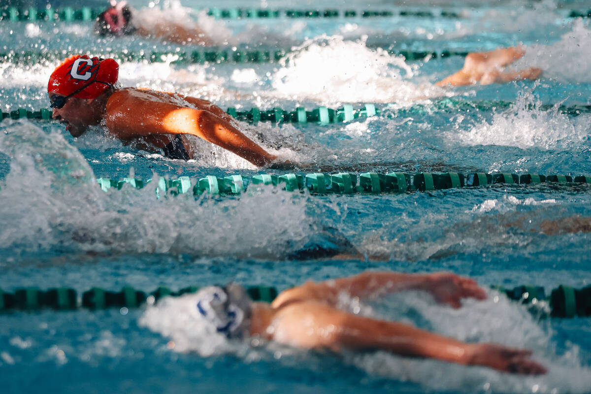 Swimmers compete in the 50 yard freestyle during a high school swim meet at Pavilion Center Poo ...