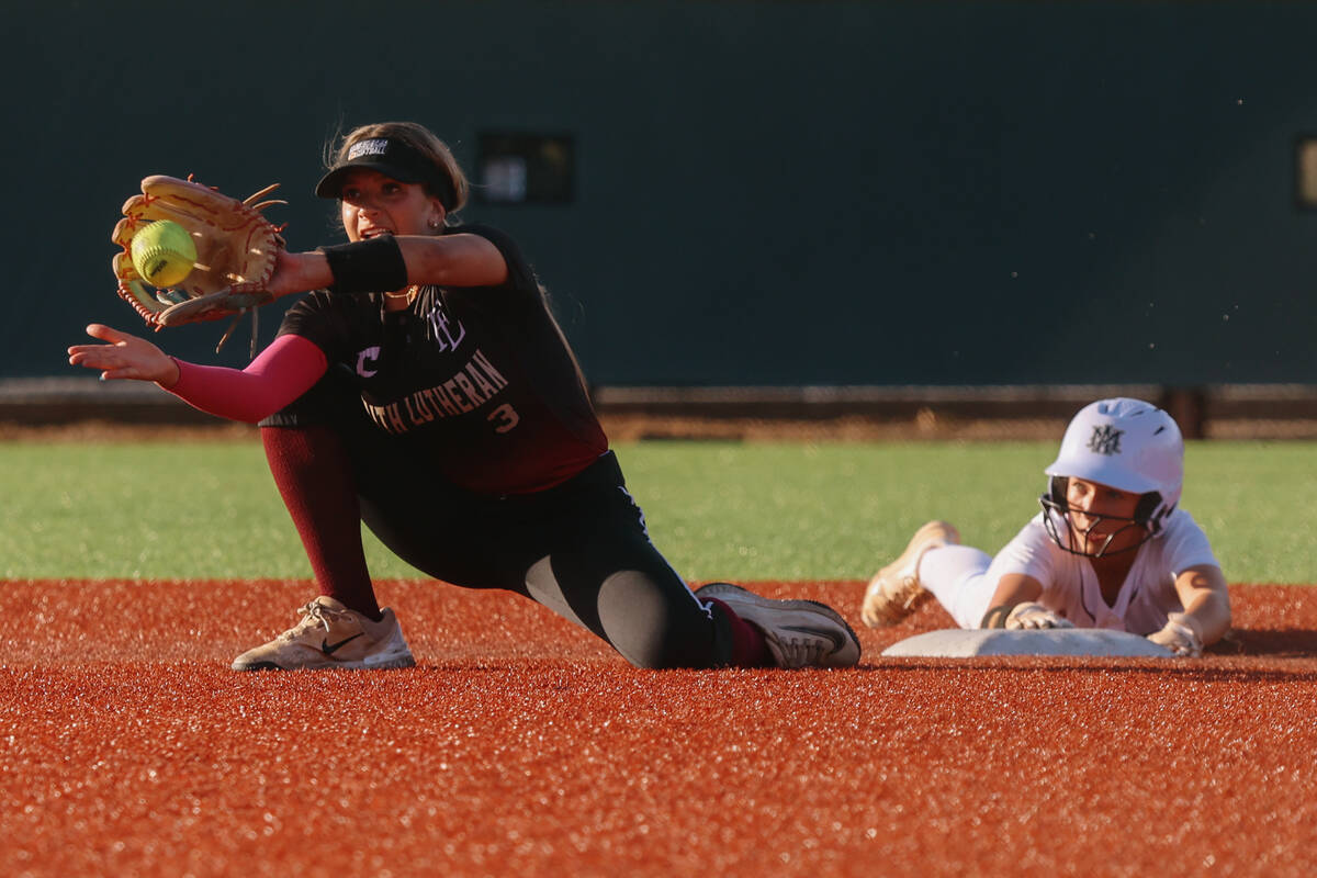 Faith Lutheran second baseman Elle Balady (3) holds out her glove to catch a ball just after De ...