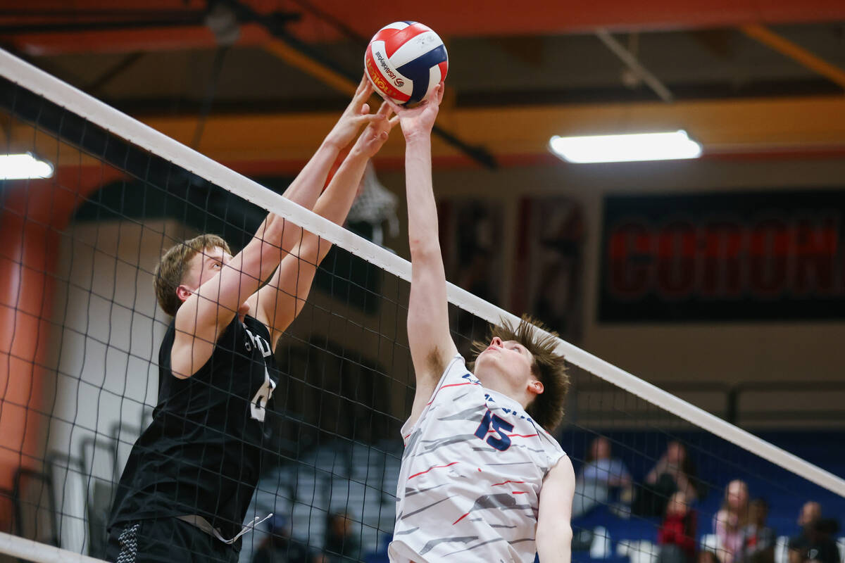 Shadow Ridge middle blocker Max Romzek (8) and Coronado setter Connor Muldoon (15) go head to h ...